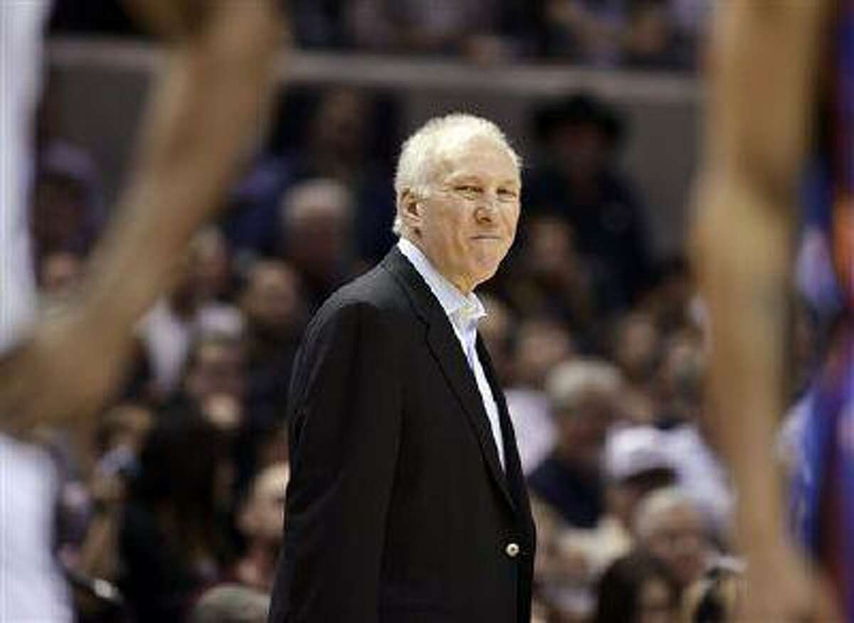 San Antonio Spurs head coach Gregg Popovich smirks during the second half of an NBA basketball game against the Oklahoma City Thunder, March 11, 2013, in San Antonio.