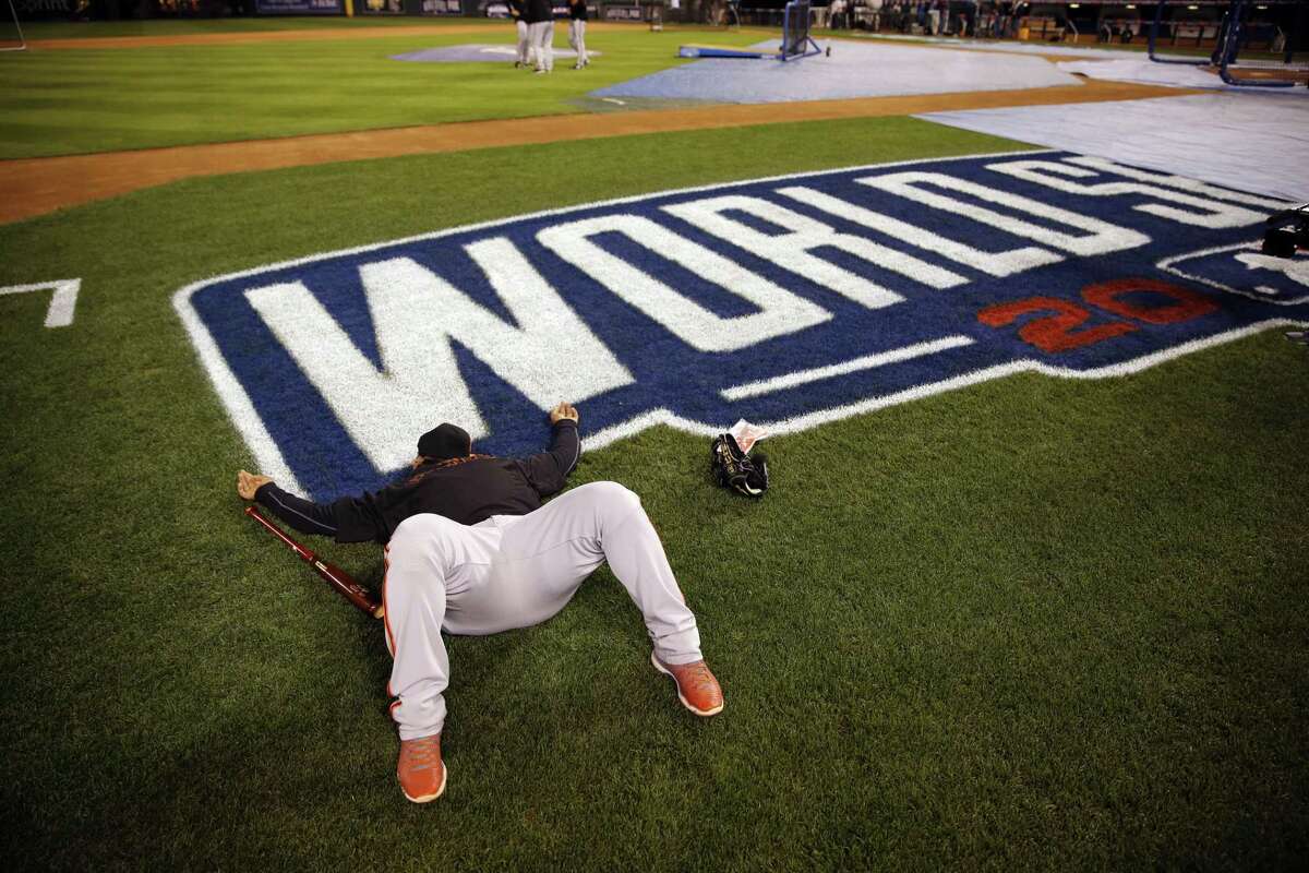 San Francisco Giants third baseman Pablo Sandoval lays down shortly after arriving at Kauffman Stadium for a workout Monday in Kansas City, Mo.