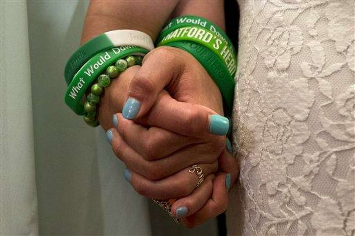 Jillian Soto, left, and Carlee Soto, sisters of Newtown, Conn. shooting victim Victoria Soto, hold hands during a news conference on Capitol Hill in Washington, Thursday, June 13, 2013, with member of Congress and Newtown families on the six month anniversary of the Newtown shootings,. (AP Photo/Jacquelyn Martin)