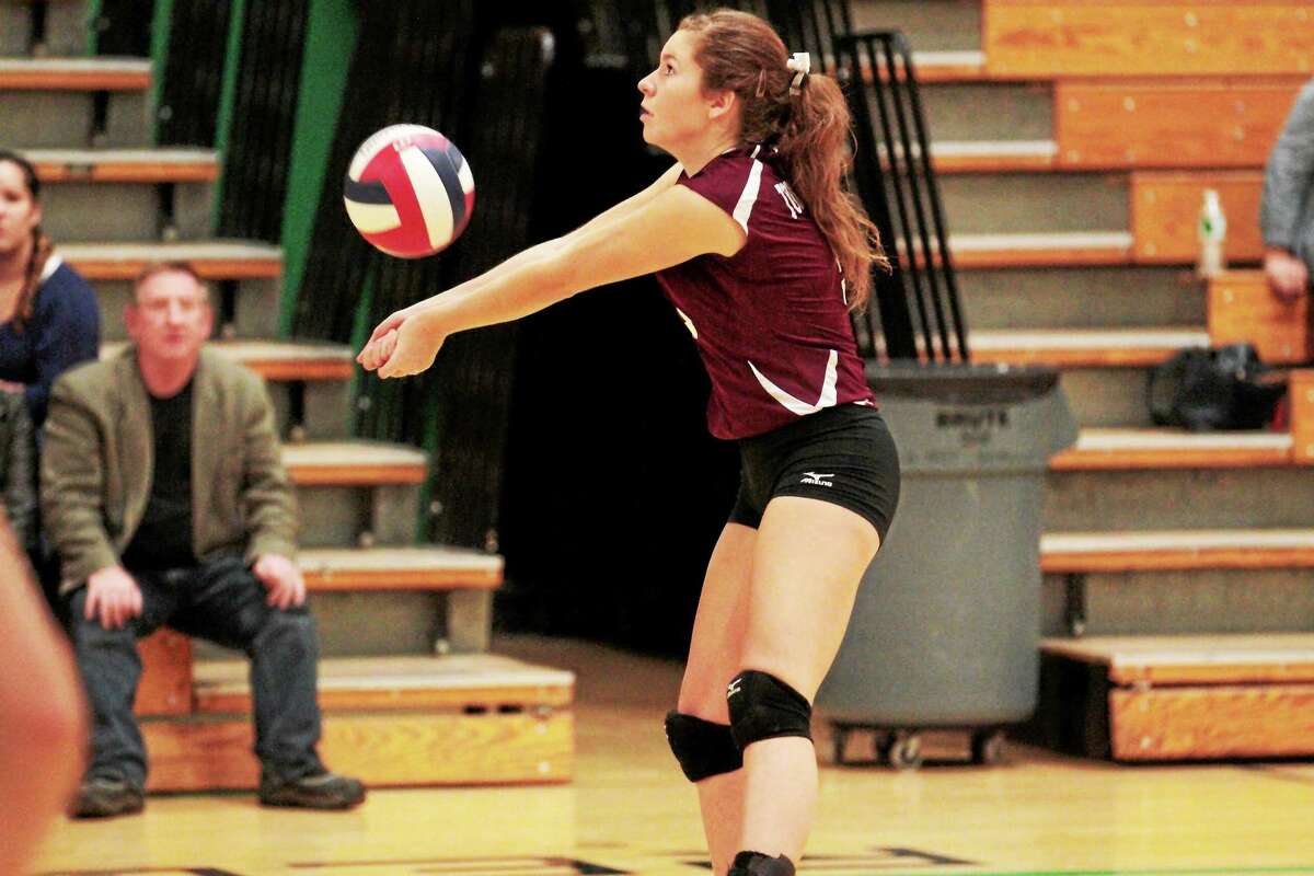 Torrington’s Carly Ruzbasan sets a ball during the Red Raiders’ 3-2 loss to Woodland Tuesday.