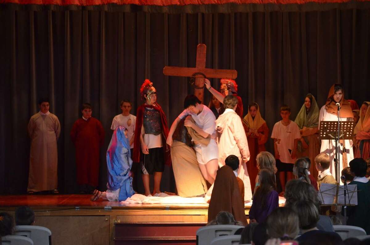 Kate Hartman/Register Citizen. St. Peter/St. Francis students performed the Stations of the Cross for classmates and parents.