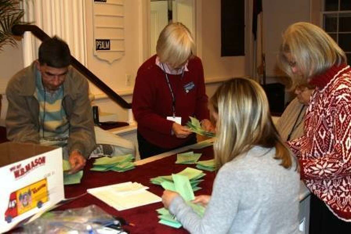 Votes being counted at the meeting Tuesday. Photo by Kathryn Boughton/The Litchfield County Times.