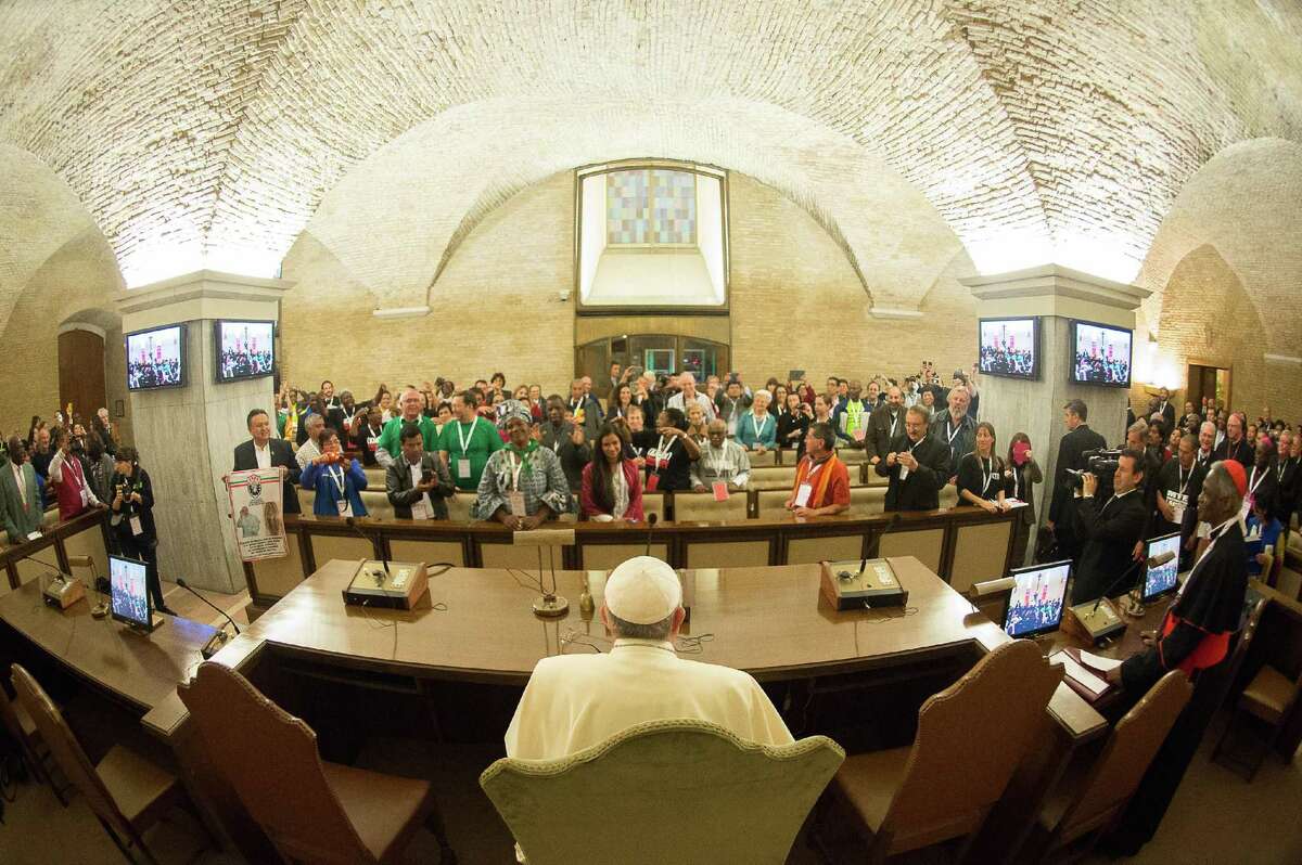 In this photo provided by the Vatican newspaper L'Osservatore Romano, Pope Francis meets with participants of the Global Meeting of Popular Movements, at the Vatican, Tuesday, Oct. 28, 2014. (AP Photo/L'Osservatore Romano)