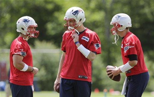 Quarterbacks Tim Tebow (5) and Tom Brady (12) of the New England Patriots  run through drills during a joint practice with the Tampa Bay Buccaneers in  Foxborough, Massachusetts, on Tuesday, August 13