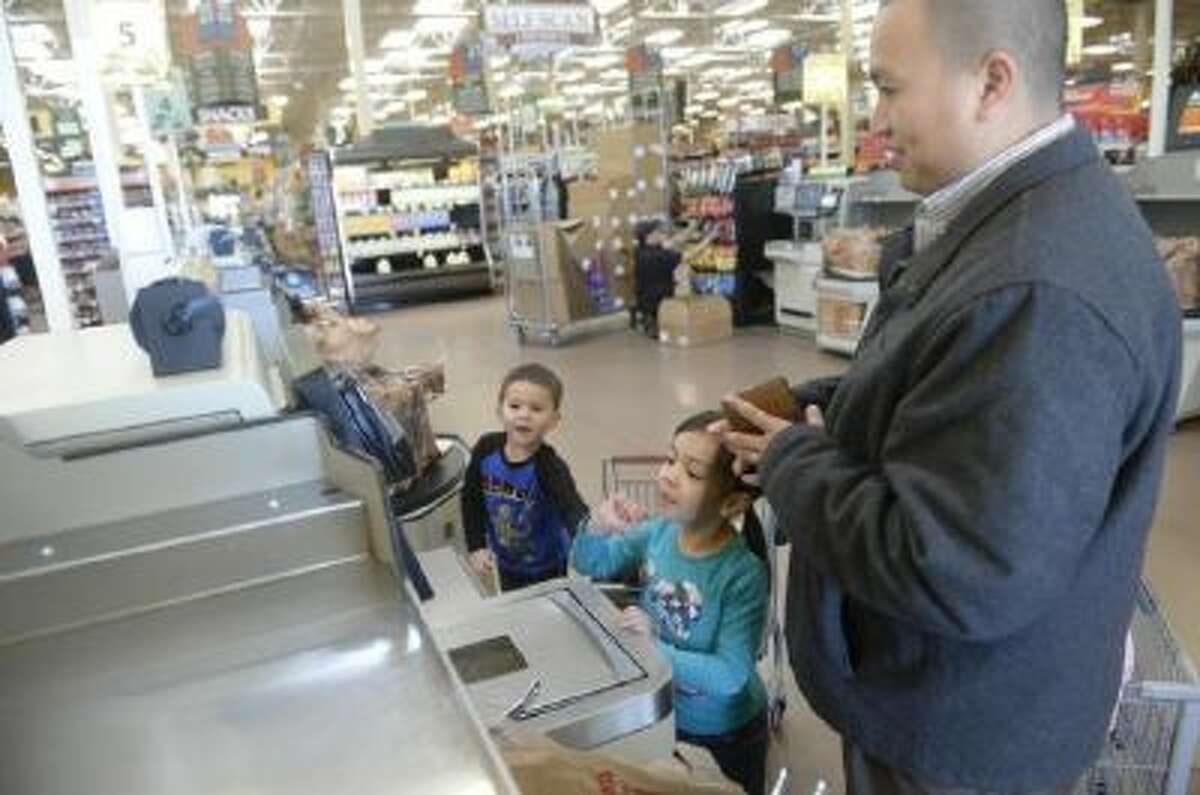 Paolo Diaz mixes a teachable moment with a fun outing to the grocery store with his daughter Maile, 6, and son Elijah, 3.