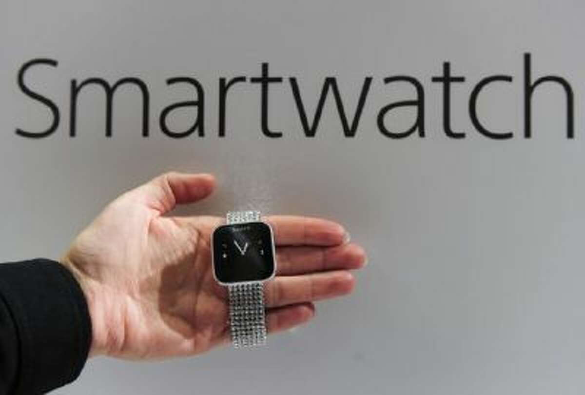 A hostess shows a smartwatch by Sony on Feb. 27, 2013 at the Mobile World Congress.
