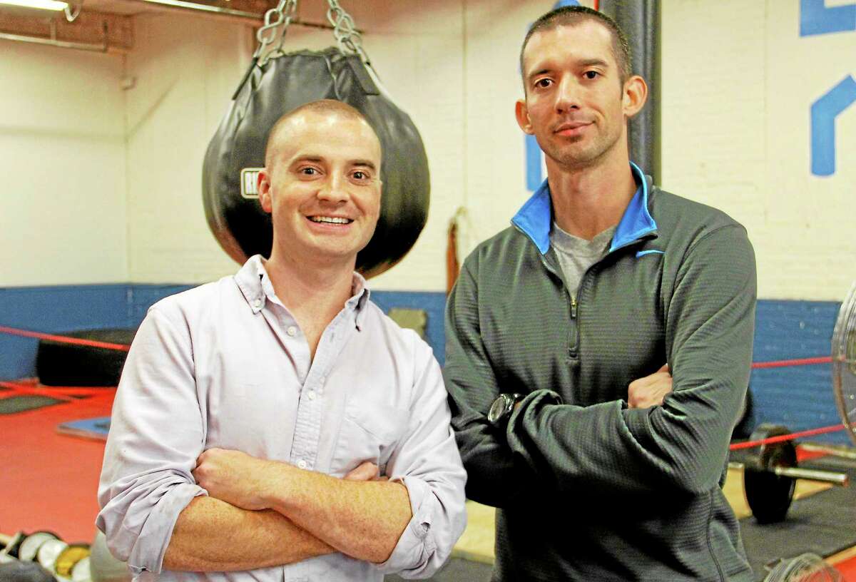 James O’Brien (left) and Matthew Harrington inside their fitness center on Tuesday, Oct. 15. The two men are veterans from Norfolk who between them served five tours in Afghanistan and Iraq. They decided to open a fitness center because it had been an aspiration for the two men.