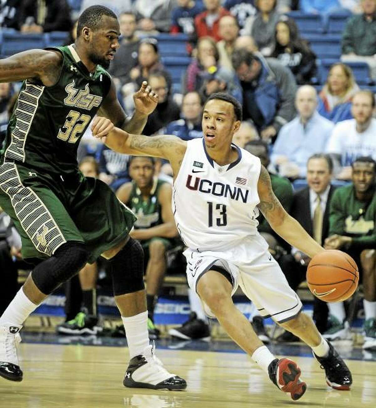 Connecticut's Shabazz Napier, right, drives past South Florida's Toarlyn Fitzpatrick during the first half of an NCAA college basketball game in Storrs, Conn., Sunday, Feb. 3, 2013. (AP Photo/Fred Beckham)