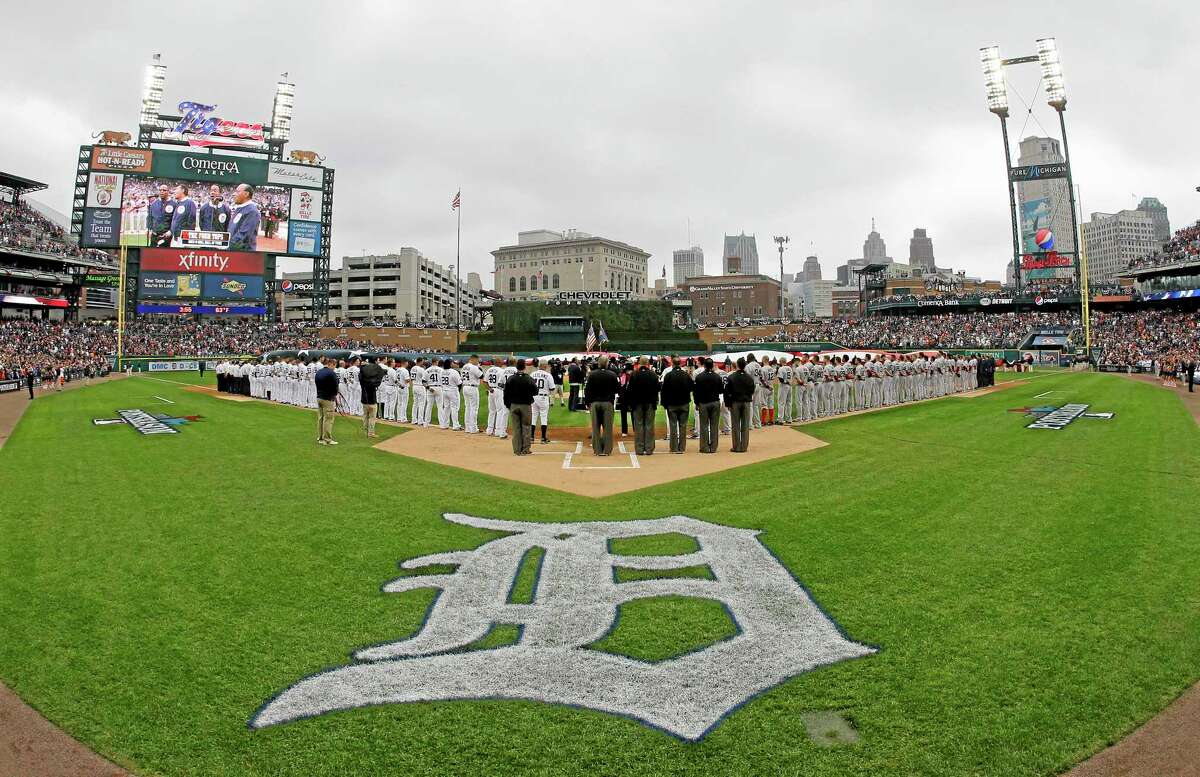 Umpires line up, keeping open a spot to honor umpire Wally Bell, who died Monday of a heart attack, during the national anthem before Game 3 of the American League championship series between the Tigers and the Boston Red Sox on Tuesday in Detroit.