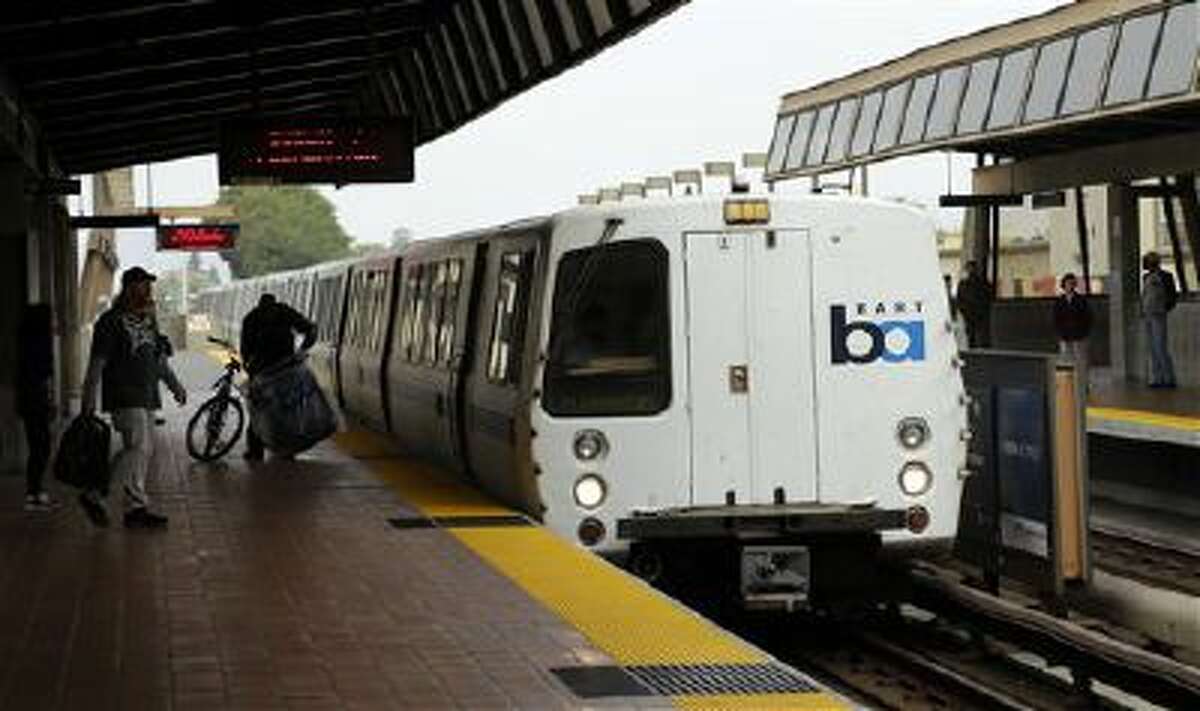 Bay Area Rapid Transit travelers wait to board an arriving train in Oakland, Calif., on Oct. 12. BART and union leaders resumed negotiations Monday.