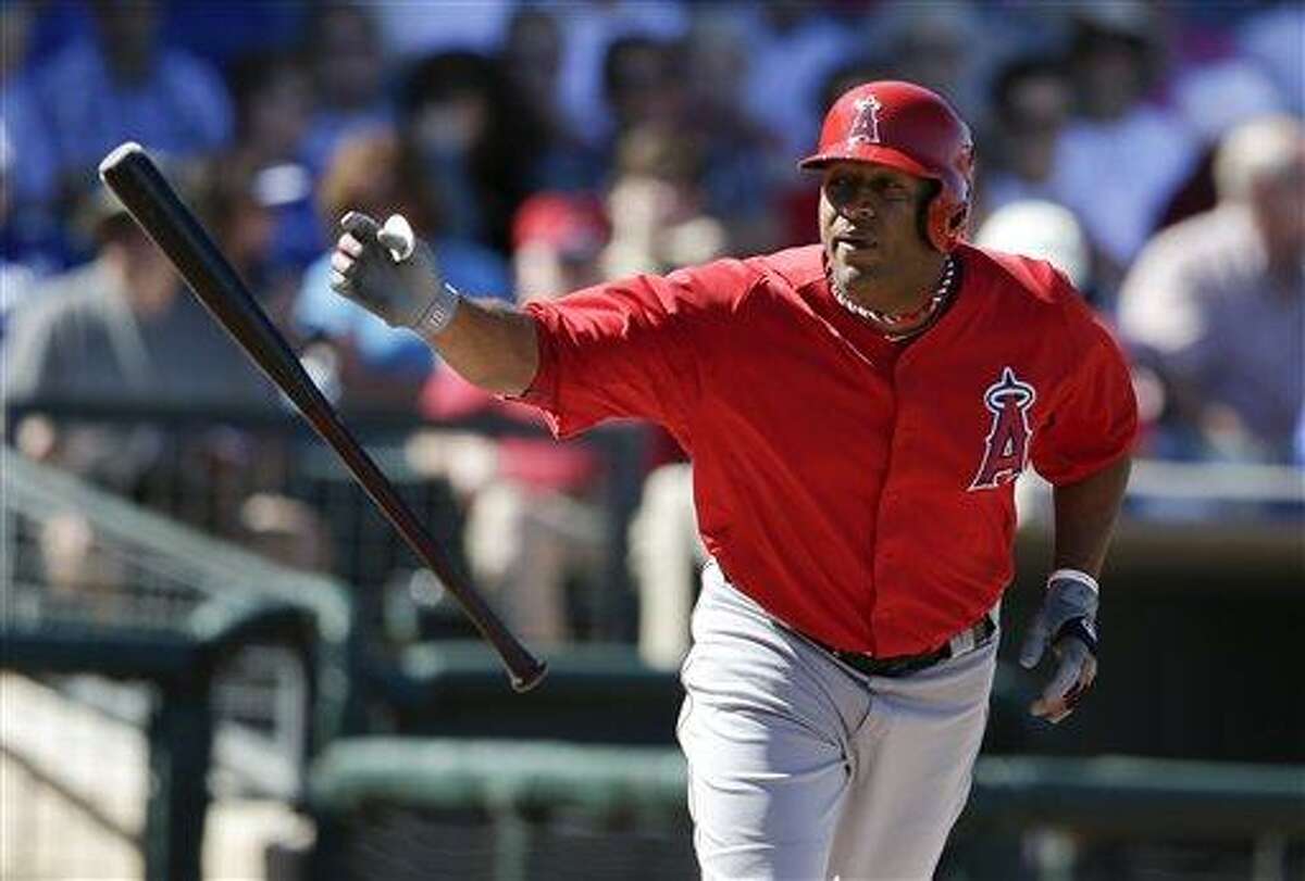 Los Angeles Angels left fielder Vernon Wells throws his bat after picking up a walk against the Kansas City Royals in an exhibition spring training baseball game Sunday, March 10, 2013, in Surprise, Ariz. (AP Photo/Gregory Bull)