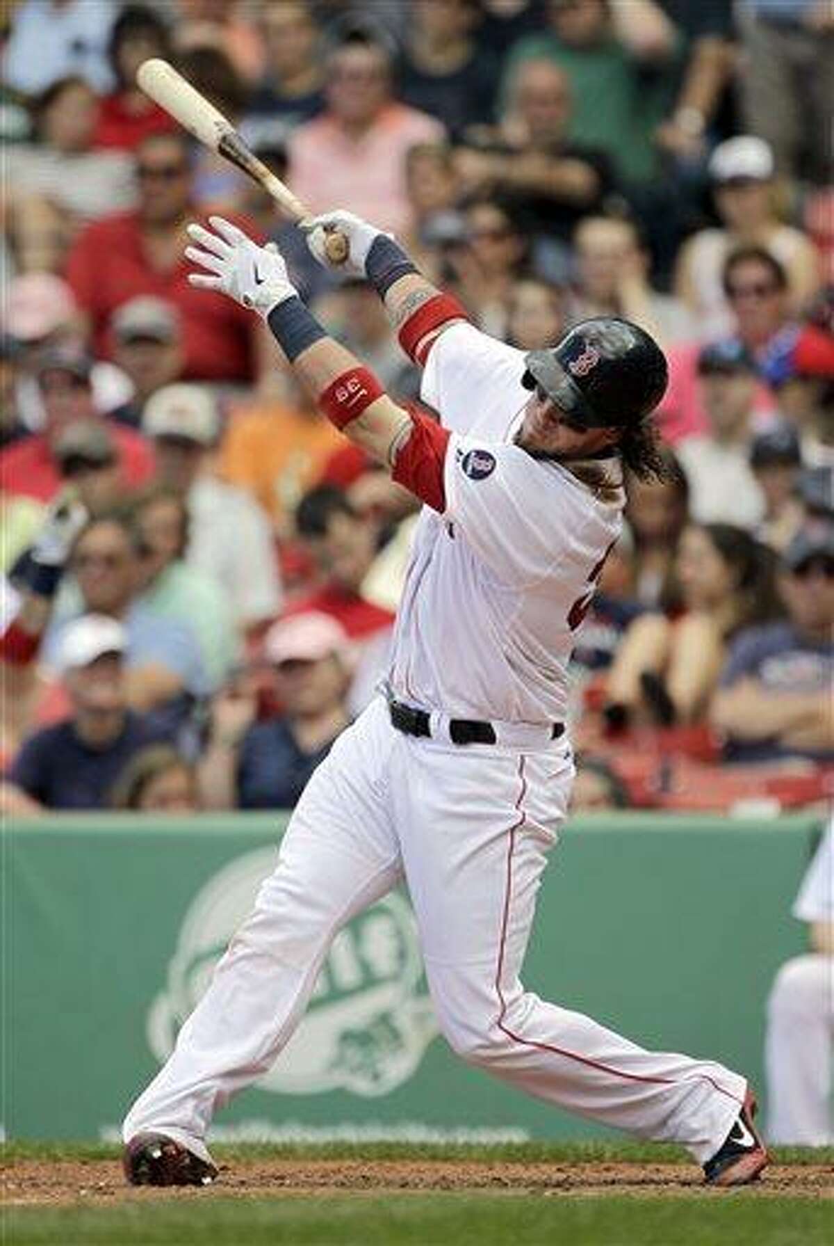 Boston Red Sox's Jarrod Saltalamacchia (39) follows through on a home run during the sixth inning of a baseball game against the Los Angeles Angels, Sunday, June 9, 2013, at Fenway Park in Boston. Saltalamacchia hit two home runs in the Red Sox 10-5 win. (AP Photo/Mary Schwalm)