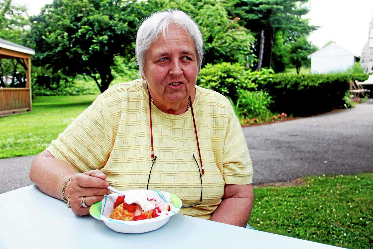 Barbara Bambakidou enjoys a biscuit with strawberries and whipped cream during the Strawberry Festival held by the Center Congregational Church on Sunday, June 29, 2014, in Torrington. Esteban L. Hernandez Register Citizen