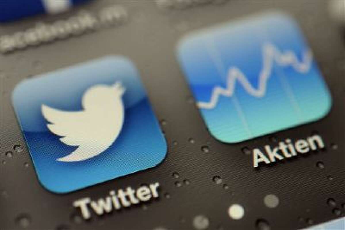 A Twitter App and stock tracker are shown on an iPhone in this Sept. 13 file photo.