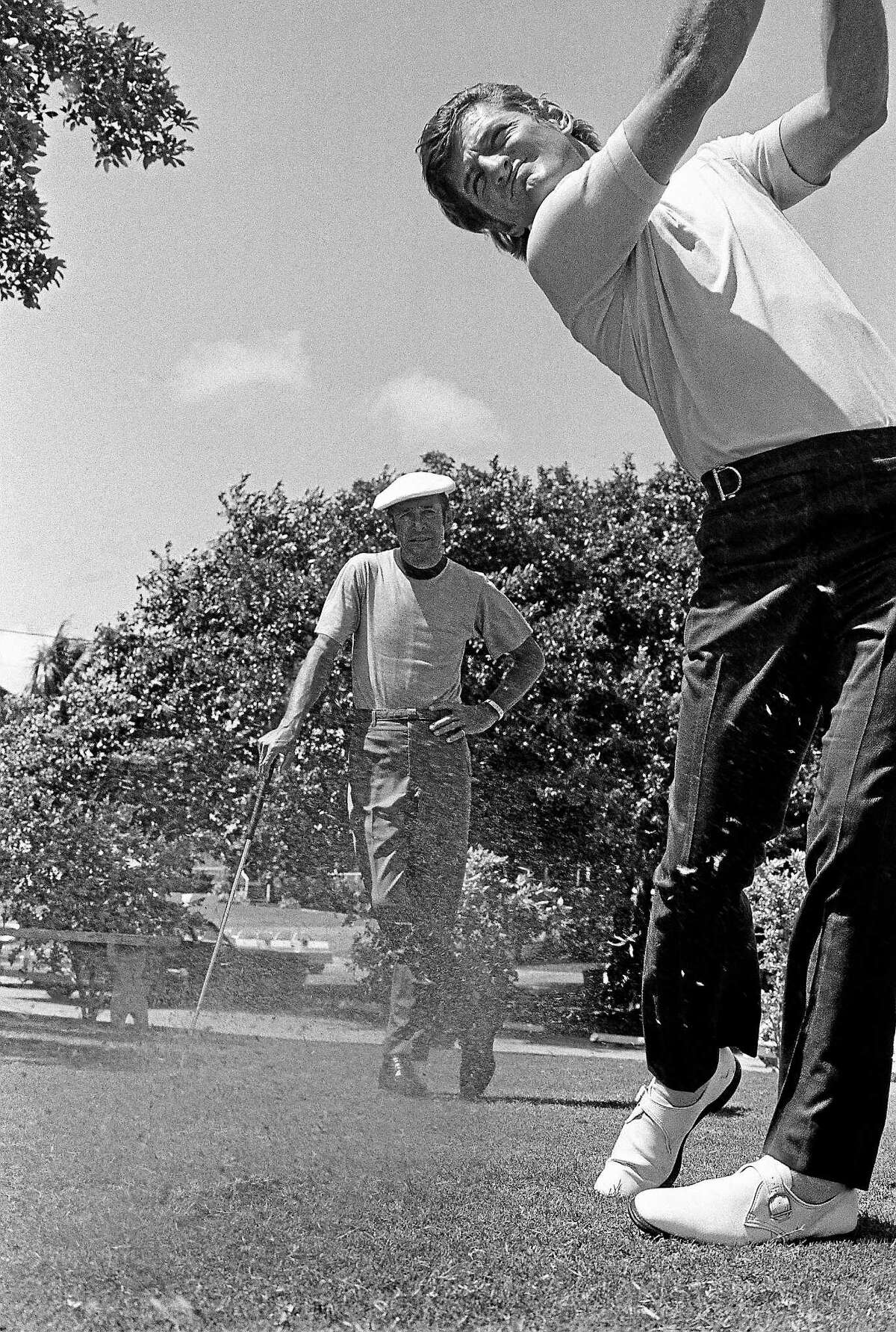 Former major league outfielder, and current Chicago White Sox broadcaster, Ken “Hawk” Harrelson follows through on his swing while his teacher, Bob Toski, look on during a practice session in September 1971. Ken Duke, the 2013 Travelers Championship winner, is a current pupil of the 87-year-old Toski, who recently returned to the scene of his 1953 Insurance City Open tournament victory.