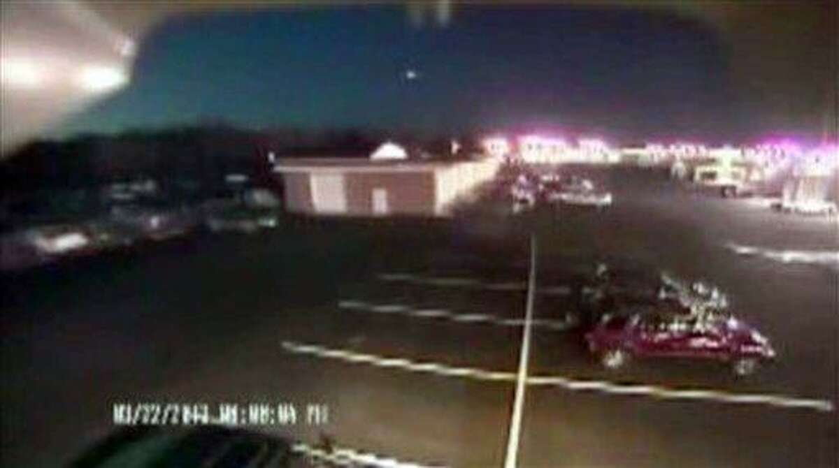 In this image taken from video provided by Tom Hopkins of Hopkins Automotive Group, a bright flash of light, top center, streaks across the early-evening sky in what experts say was almost certainly a meteor coming down, Friday, March 22, 2013 in Seaford, Del. Bill Cooke of NASA's Meteoroid Environmental Office said the flash appears to be "a single meteor event." He said it "looks to be a fireball that moved roughly toward the southeast, going on visual reports." (AP Photo/Hopkins Automotive Group)