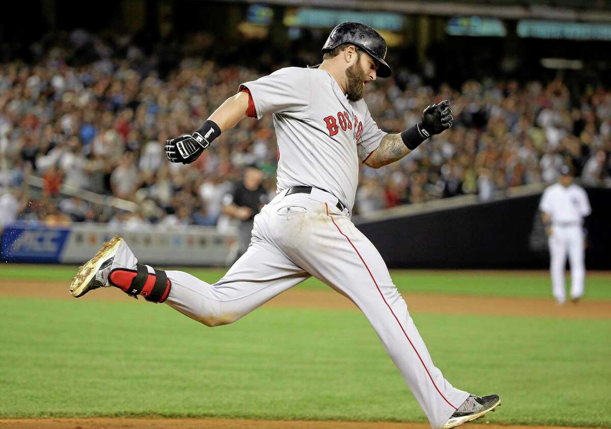 Boston’s Mike Napoli rounds first base after hitting a solo home run against the Yankees in the ninth inning Saturday in New York. The Red Sox won 2-1.