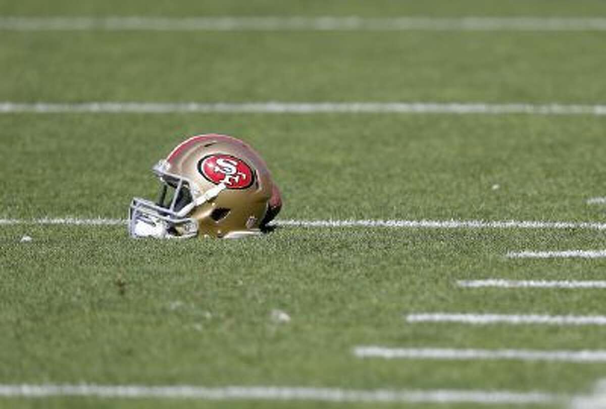 A San Francisco 49ers helmet rests on the field before an NFL football game against the Arizona Cardinals in San Francisco, Sunday, Oct. 13, 2013.