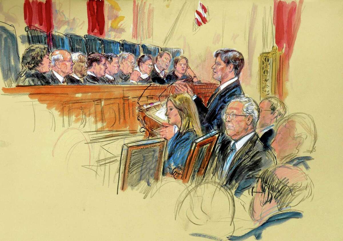 This artist rendering shows Senate Minority Leader Mitch McConnell of Ky., seated, center, listening as attorney Bobby Burchfield,standing, right, argues for McConnell during the Supreme Court's hearing on campaign finance, Tuesday, Oct. 8, 2013, at the Supreme Court in Washington. Justices, from left are, Sonia Sotomayor, Stephen Breyer, Clarence Thomas, Antonin Scalia, Chief Justice John Roberts, Anthony Kennedy, Ruth Bader Ginsburg, Samuel Alito and Elena Kagan. (AP Photo/Dana Verkouteren)