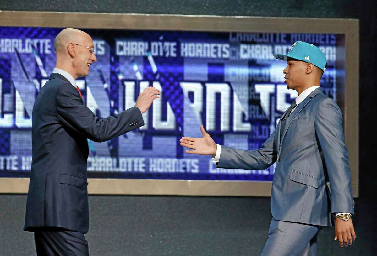 UConn’s Shabazz Napier, right, is greeted by NBA Commissioner Adam Silver after being selected as the 24th overall pick in Thursday’s NBA draft.