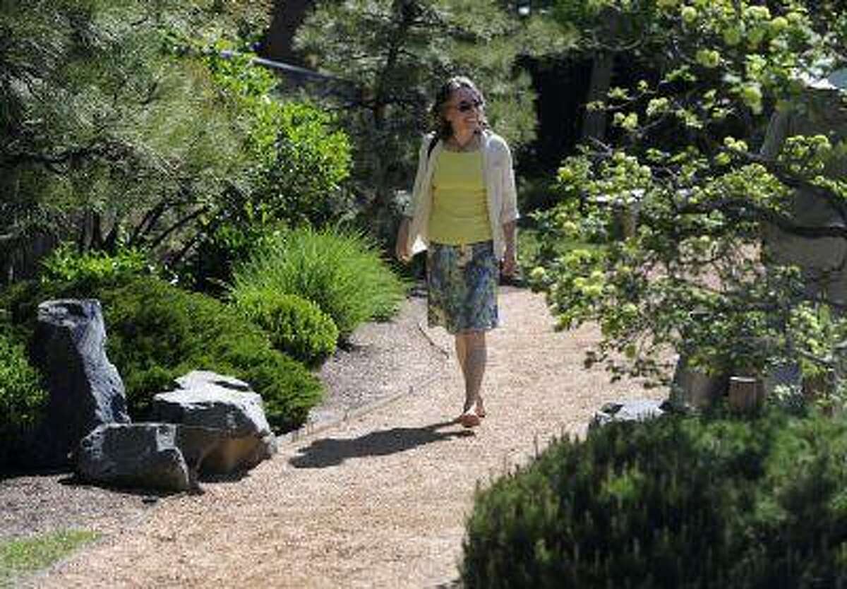 Kriste Brushaber takes a barefoot walk through the Denver Botanic Gardens, making sure to walk dirt paths and the reflexology path. (Kathryn Scott Osler/The Denver Post)