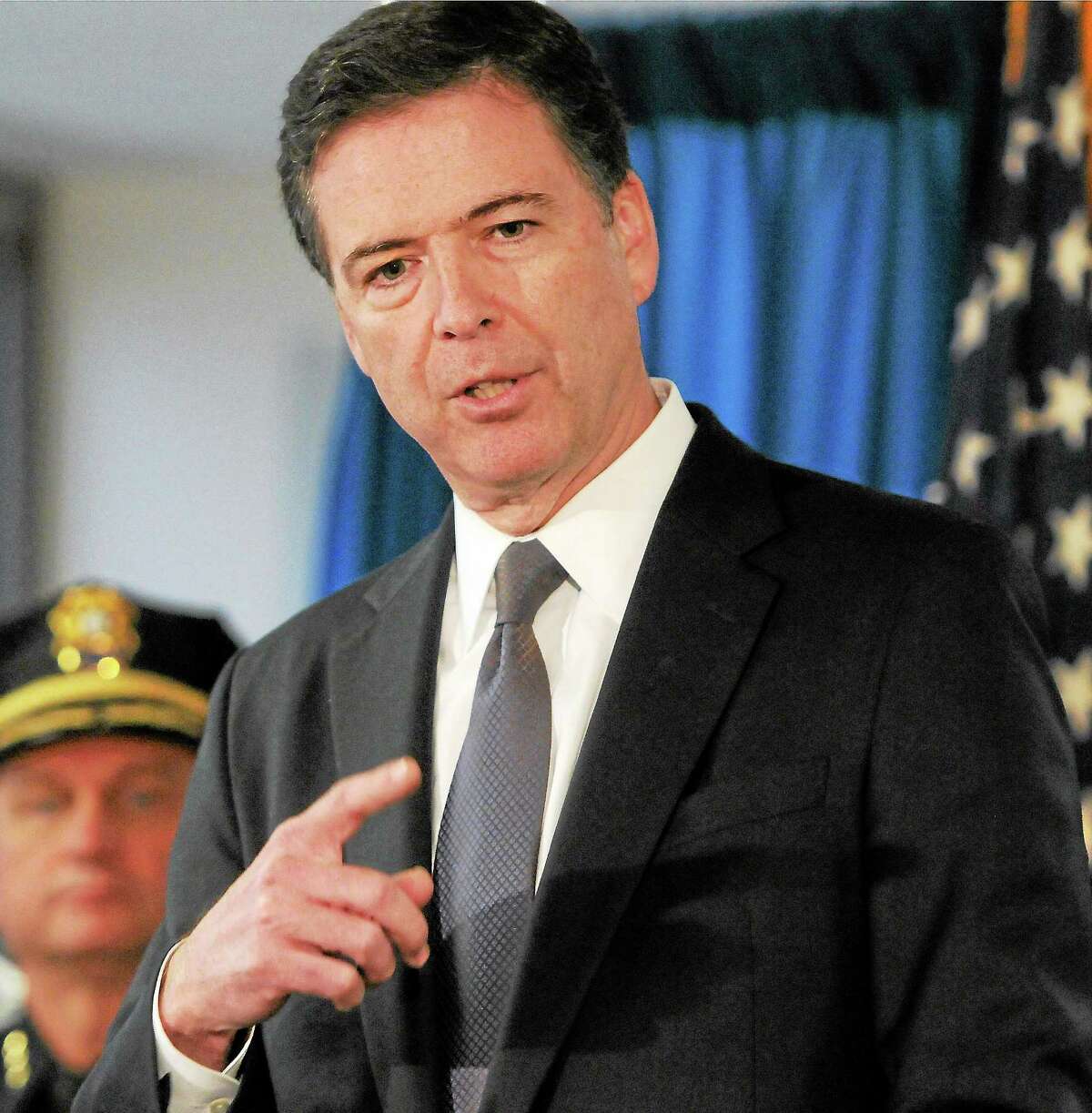 FBI Director James Comey answers questions at a press conference during a December 2013 visit to the New Haven FBI Field Office and with Police Chief in Connecticut and the Connecticut State Police.