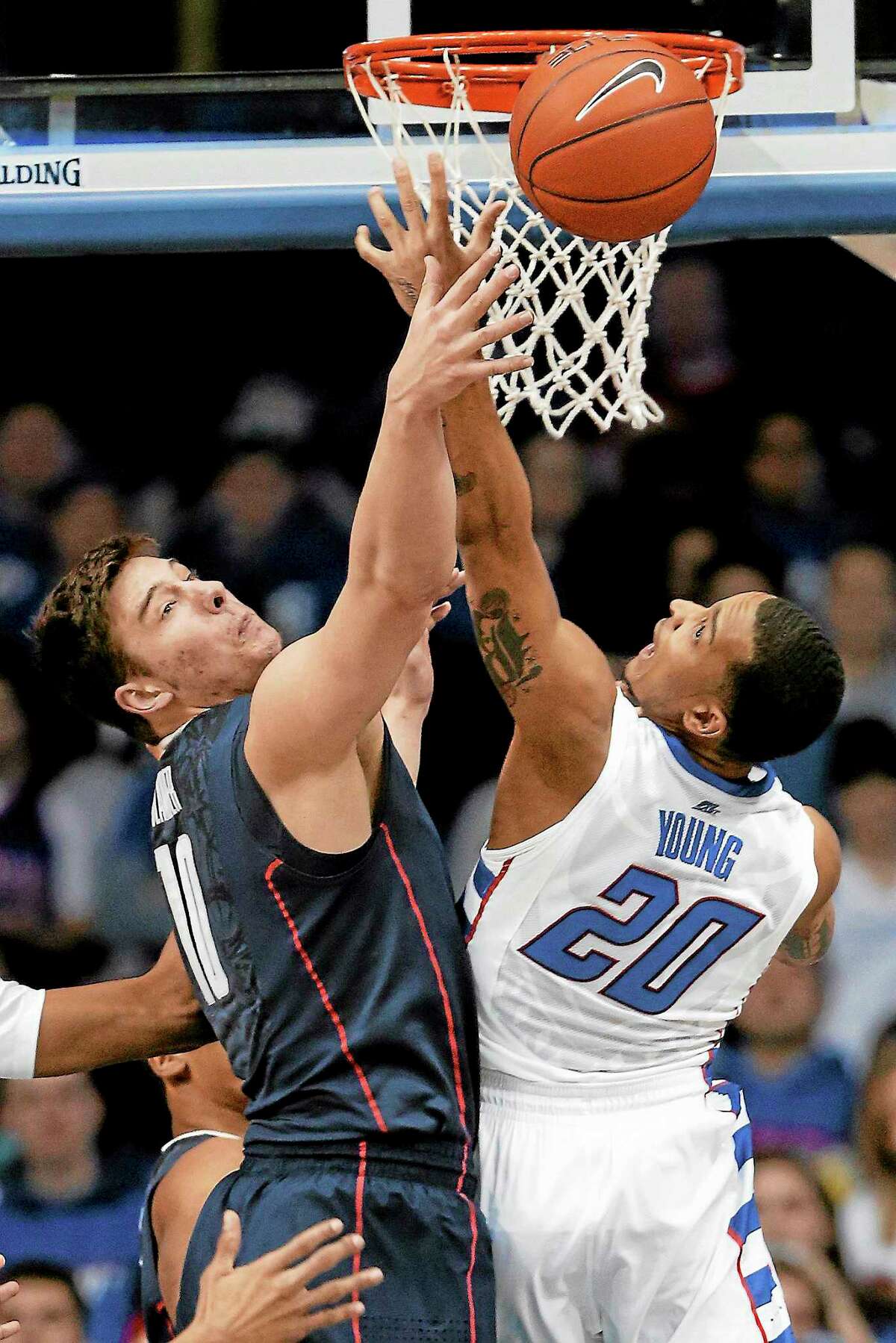 UConn forward Tyler Olander, left, and DePaul guard Brandon Young battle for a rebound during a game last season in Rosemont, Ill.