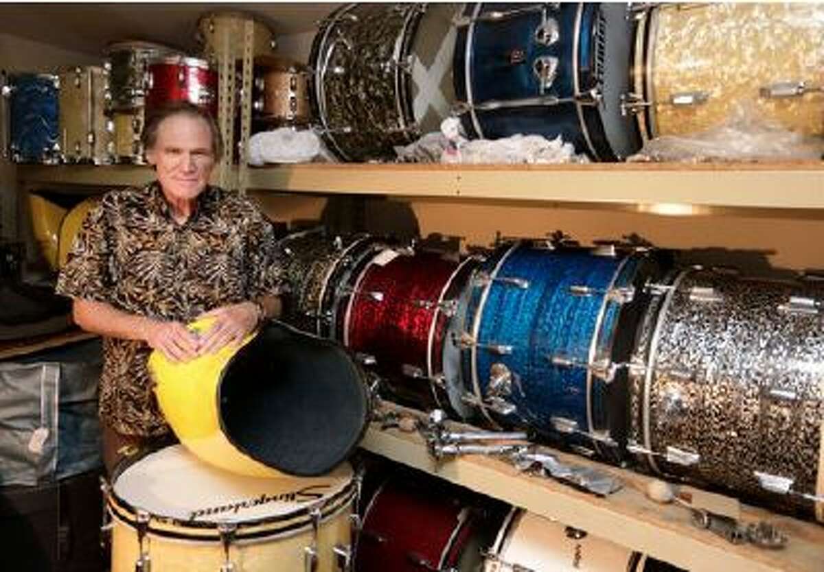 This photo taken Oct. 3, 2013 shows James Glay poses with his collection of vintage drums in Arlington Heights, Ill. Every passing month and unanswered resume dimmed Glay's optimism more. His career in sales was ended by a layoff. (M. Spencer Green/AP)