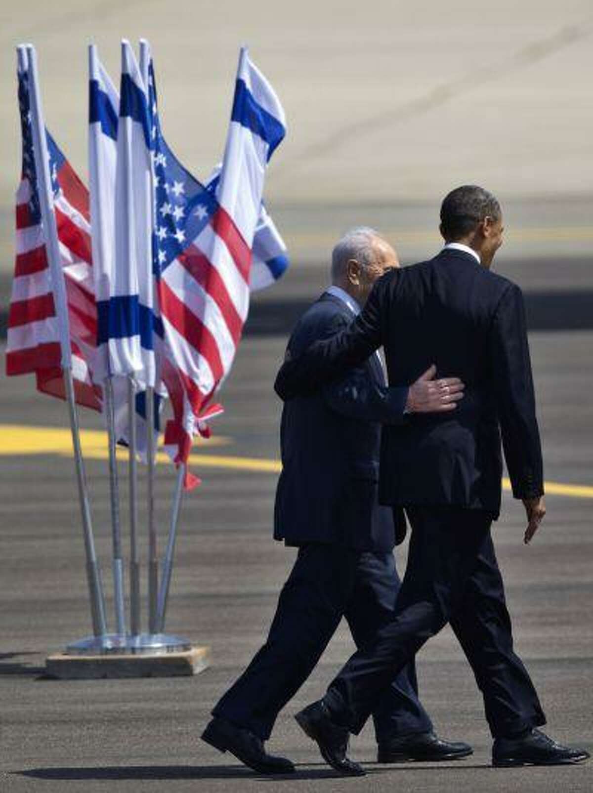 US President Barack Obama, right, and Israel's President Shimon Peres walk together at the end of welcoming ceremony upon Obama's arrival at Ben Gurion airport near Tel Aviv, Israel, Wednesday, March 20, 2013. President Barack Obama is declaring common cause with Israel, highlighting the bonds between the United States and its Mideast ally. He says he has made Israel the first stop of the first trip of his second term to restate his commitment to Israel's security. (AP Photo/Ariel Schalit)