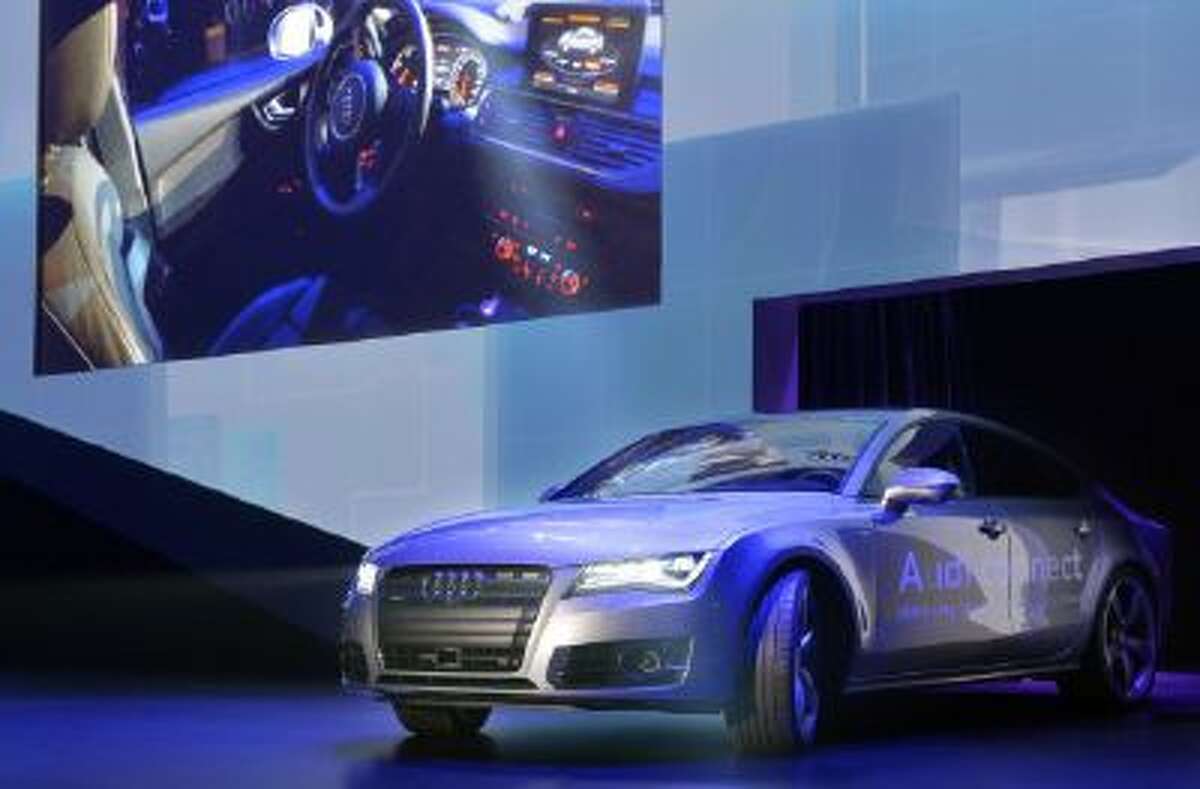 Audi's autonomous car drives on stage during the Audi keynote at the International Consumer Electronics Show, Monday, Jan. 6, 2014, in Las Vegas.