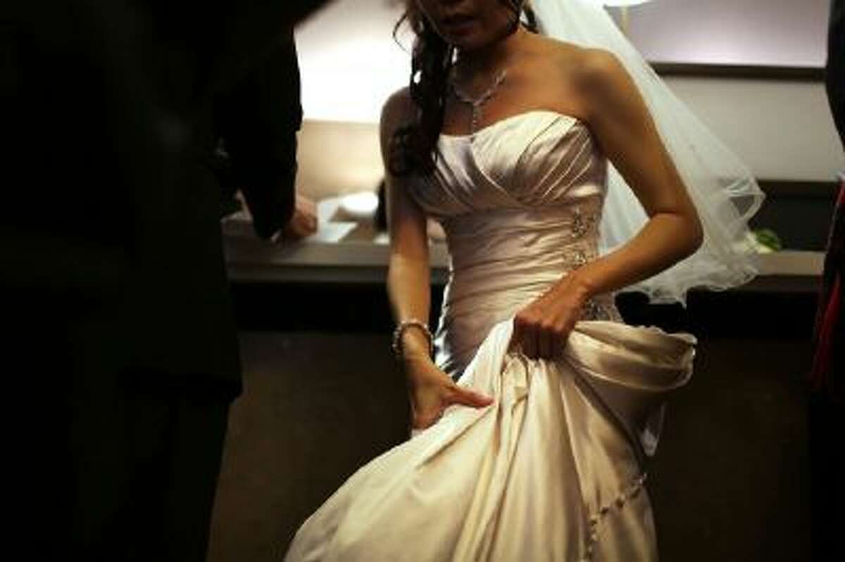 A bride waits to fill out marriage papers at a busy City Clerk's office in New York City.