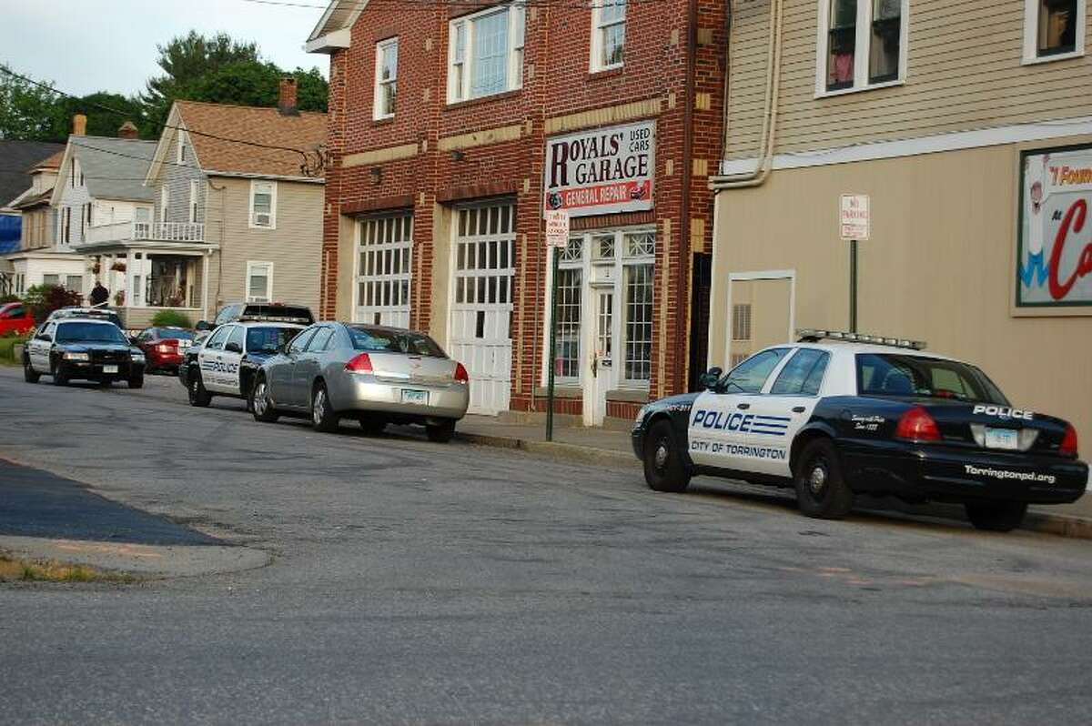 Tom Caprood/Register Citizen - Police cars seen along Calhoun Street Wednesday night, next to the Smoker's Club shop at 644 Main St. in Torrington, which was robbed at knifepoint, according to police.