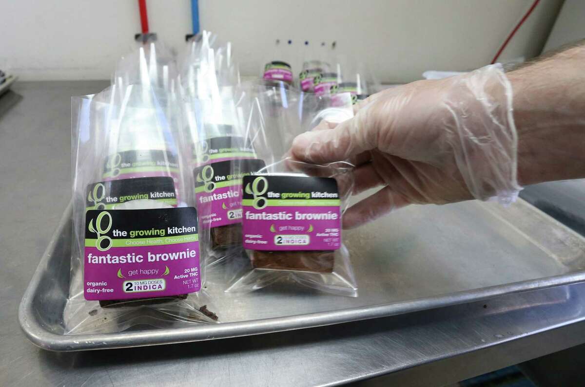 In this Sept. 26, 2014 photo, smaller-dose pot-infused brownies are packaged at The Growing Kitchen, in Boulder. Recreational marijuana sellers are reaching out to novice cannabis users with edible products that impart a milder buzz and make it easy for inexperienced customers to find a dose they are less likely to regret taking. The marketing shift is the pot-industry equivalent of selling beer and wine alongside higher-alcohol options such as whiskey and vodka. (AP Photo/Brennan Linsley)