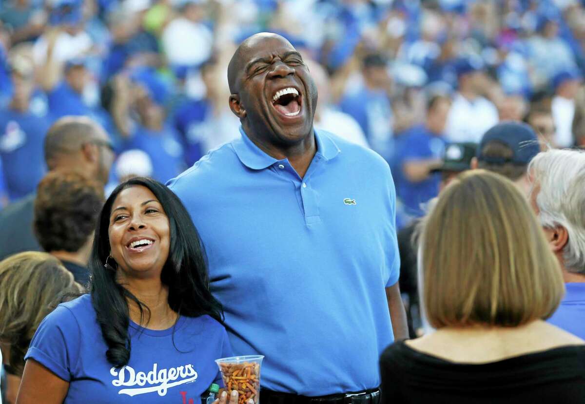 Los Angeles Dodgers owner Magic Johnson, here at Game 3 of the National League division series against the Atlanta Braves, will not return to ESPN as an NBA analyst.