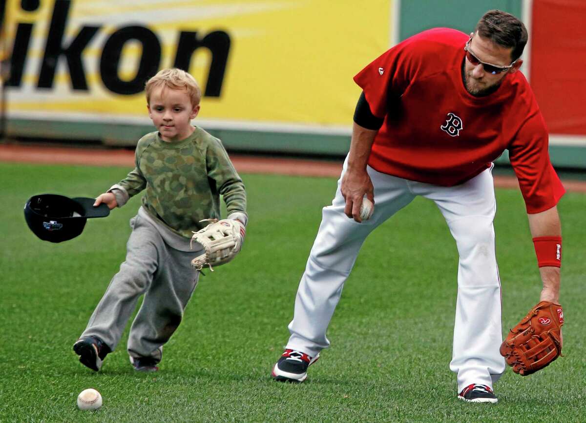 Boston Red Sox shortstop Stephen Drew plays with his son, Hank, during a team workout Thursday at Fenway Park in Boston in preparation for Game 1 of the ALCS on Saturday.