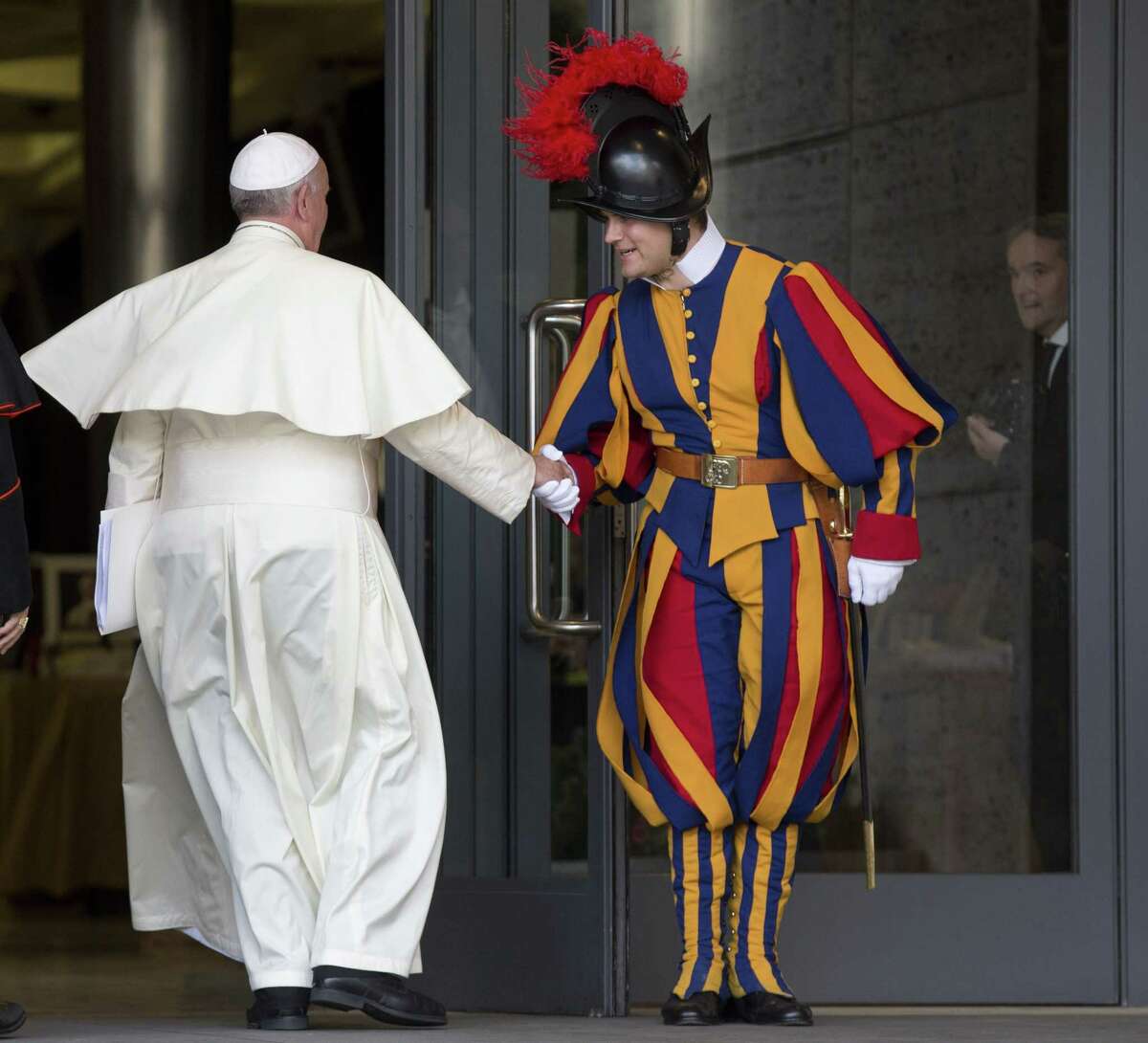Pope Francis greets a Vatican Swiss Guard as he arrives for a morning session of a two-week synod on family issues, at the Vatican, Thursday, Oct. 16, 2014. (AP Photo/Alessandra Tarantino)