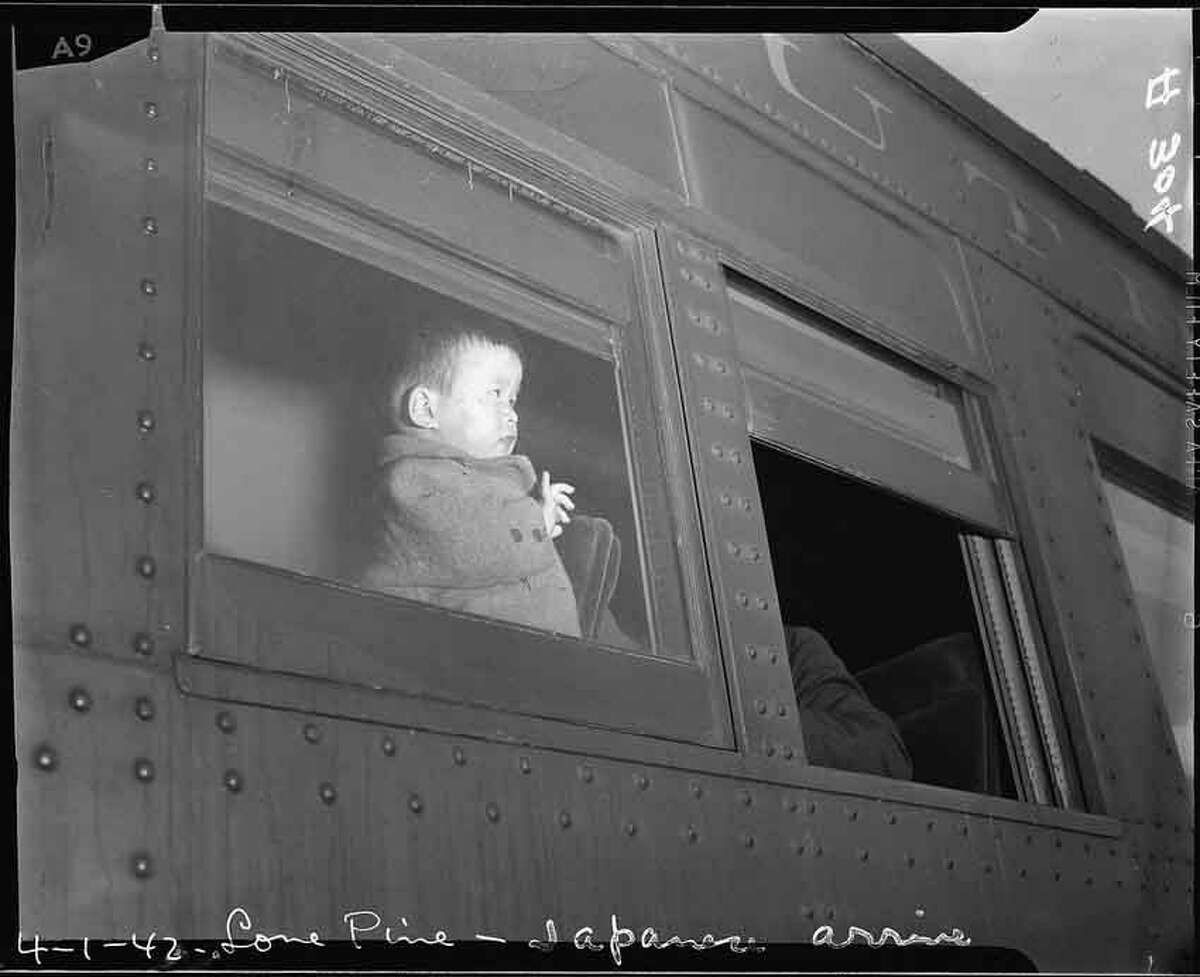 Lone Pine, California. A young evacuee of Japanese ancestry arrives here by train prior to being transferred by bus to Manzanar, now a War Relocation Authority center.