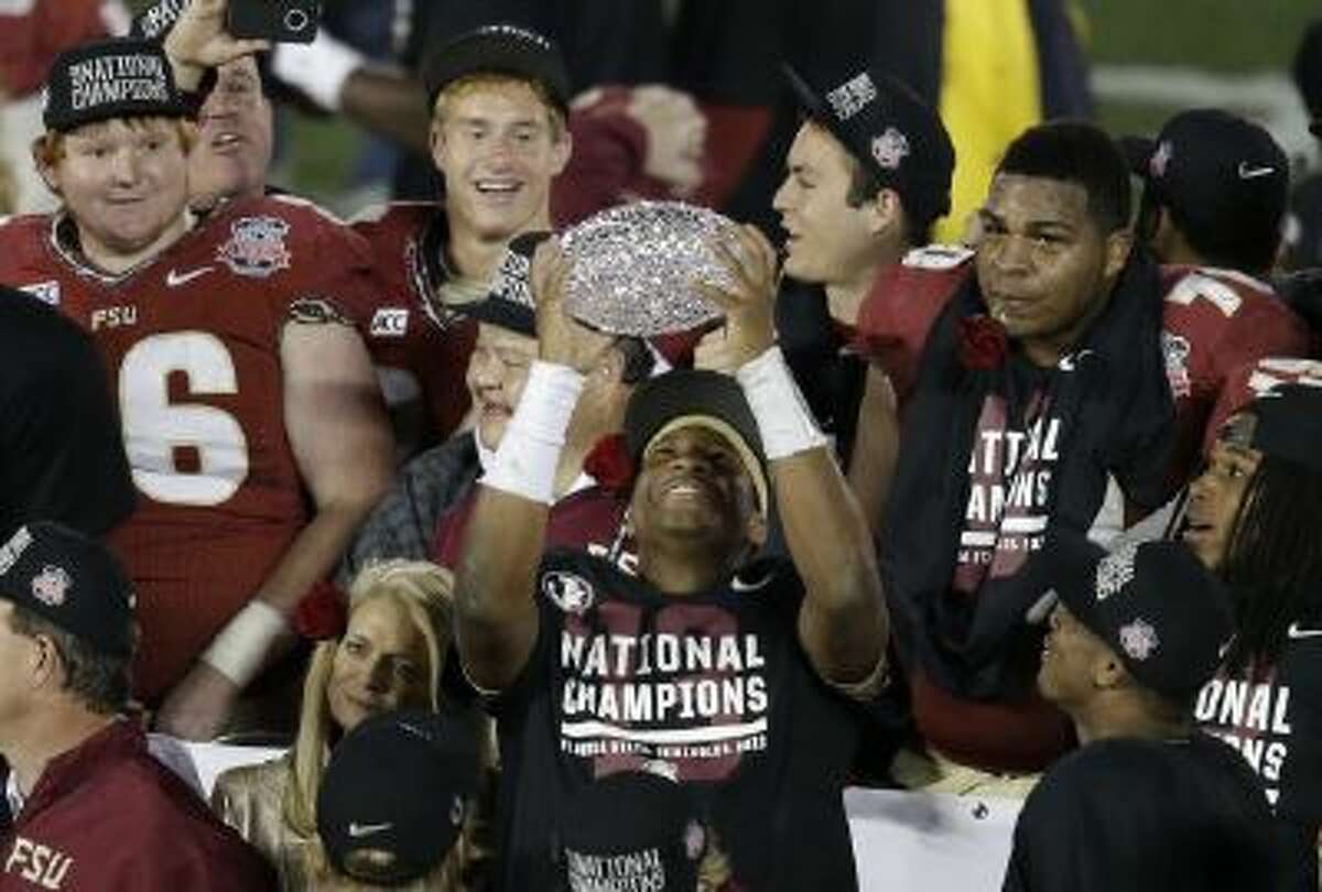 Florida State's Jameis Winston celebrates with The Coaches' Trophy after Florida State beat Auburn in the BCS National Championship Game Monday in Pasadena.