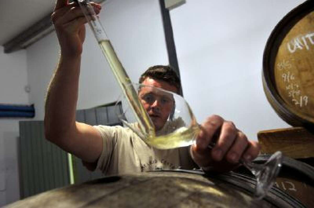 Chris Alheit tests one of his wines in Hemelrand in Western Cape on September 5, 2013. He is determined to create not only world-beating wine, but one which is distinctly South African.
