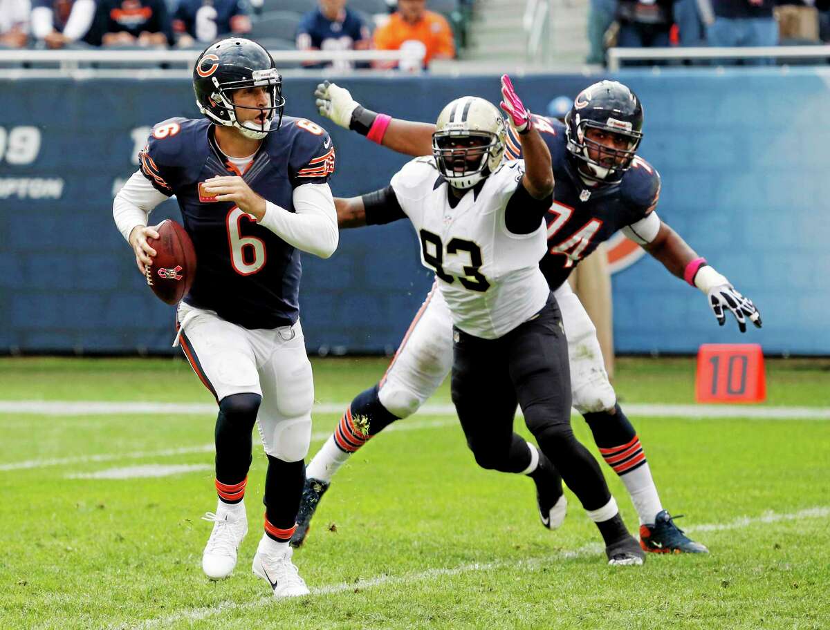Bears quarterback Jay Cutler scrambles against New Orleans Saints outside linebacker Junior Galette during the second half on Sunday in Chicago.