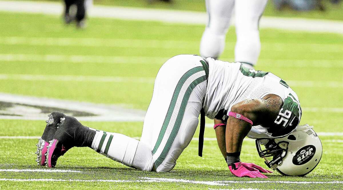 New York Jets linebacker Antwan Barnes lies on the turf after getting injured against the Falcons Monday night in Atlanta.