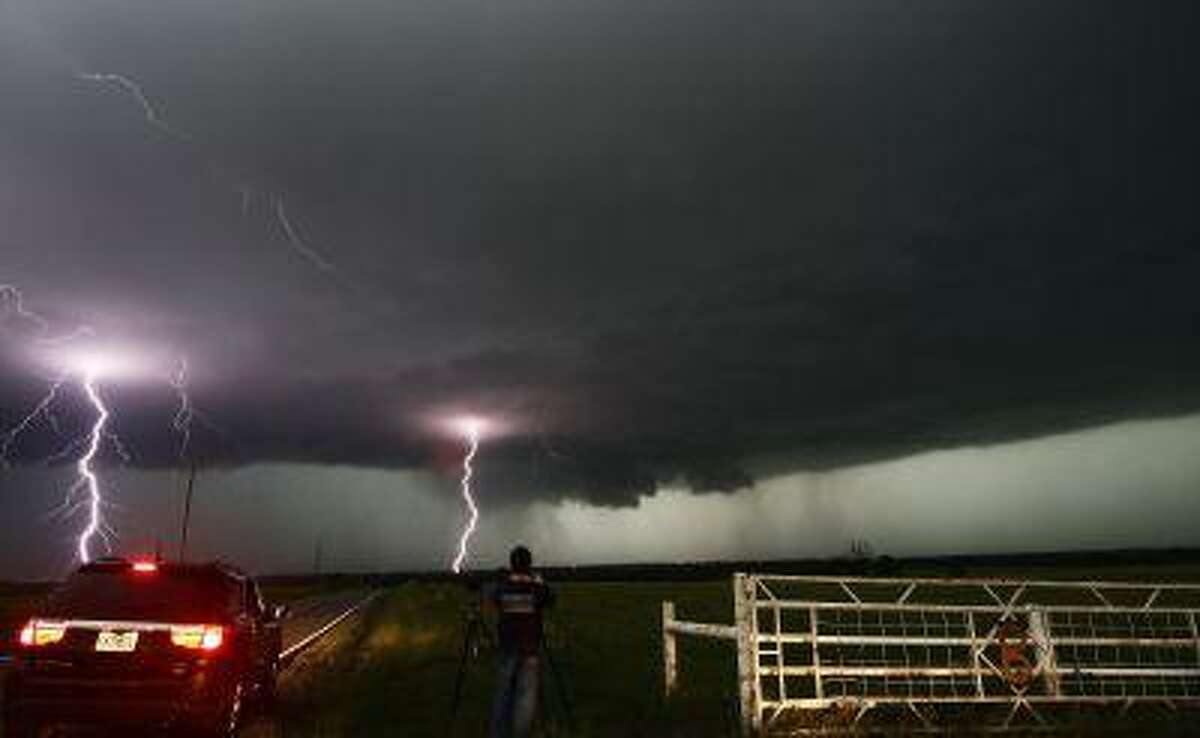 Cloud to ground lightning strikes near storm chasers during a tornadic thunderstorm in Cushing May 31, 2013.