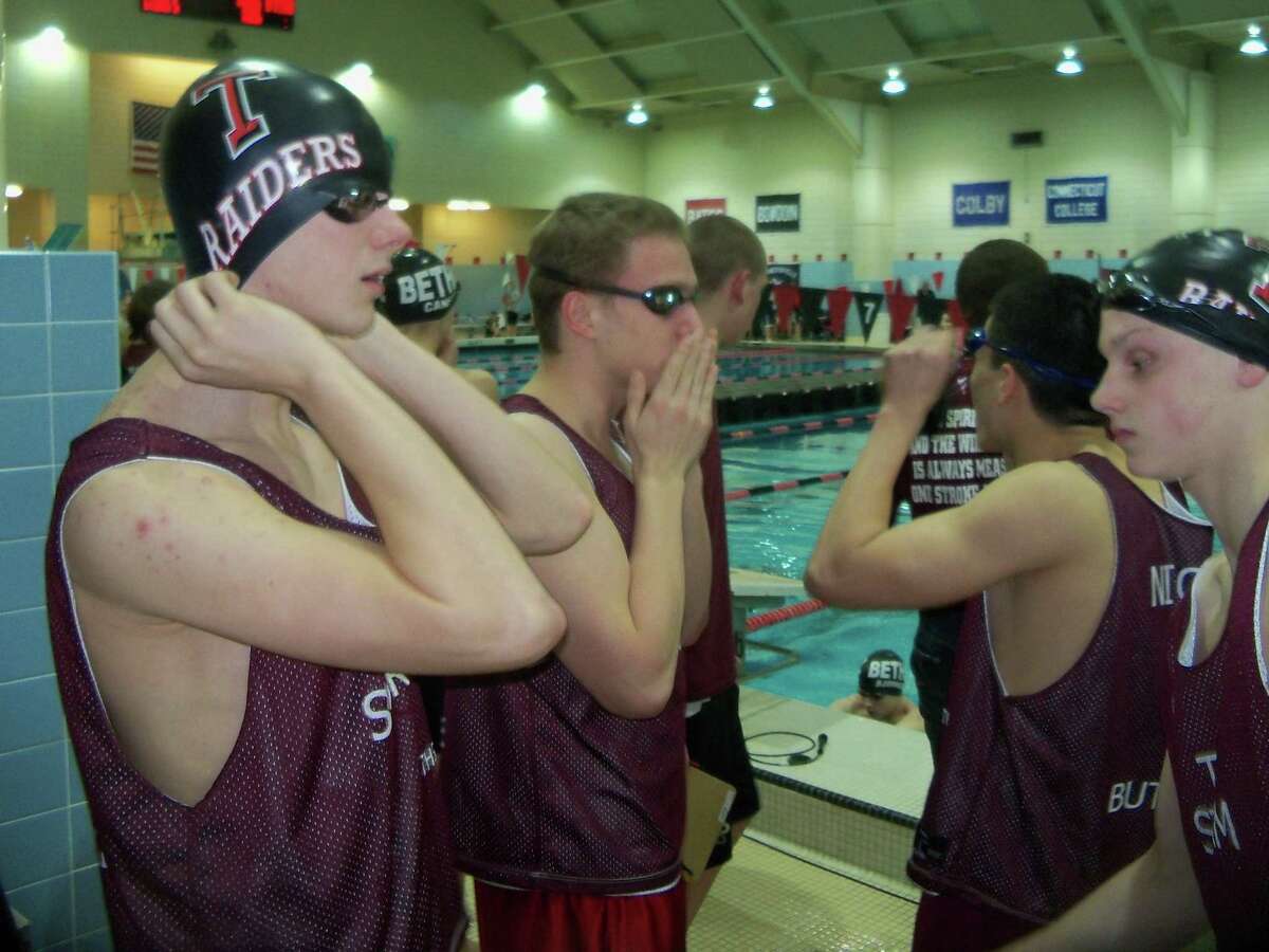 Torrington High School 200-yard IM relay team members Griffen Pelkey, Jack Wassik and Matt Traub get ready for their event in the Class M State Swimming Meet Wednesday evening. The group, along with Brad Nichols, took fourth place. Photo by Peter Wallace/Register Citizen