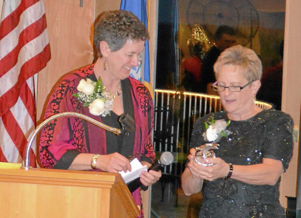 Kate Hartman/Register Citizen -- Barbara Spiegel, executive director of the Susan B. Anthony Project, left, accepts an on behalf of her staff from Gail Olsen during the United Way of Northwest Connecticutís inaugural Womenís Initiative Gala.
