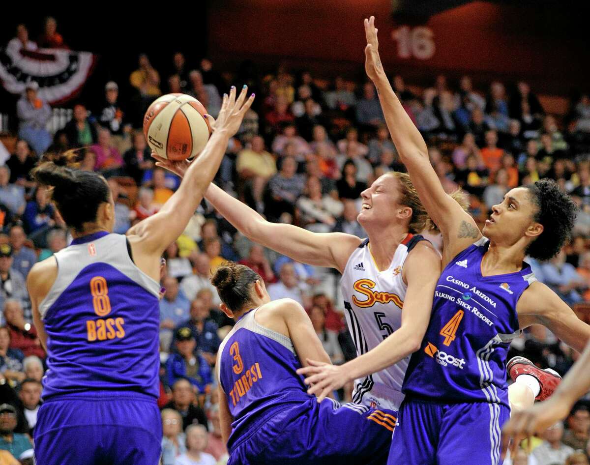 The Sun’s Kelsey Griffin is fouled by the Mercury’s Diana Taurasi (3) as Mistie Bass (8) and Candice Dupree (4) support during the second half Thursday.
