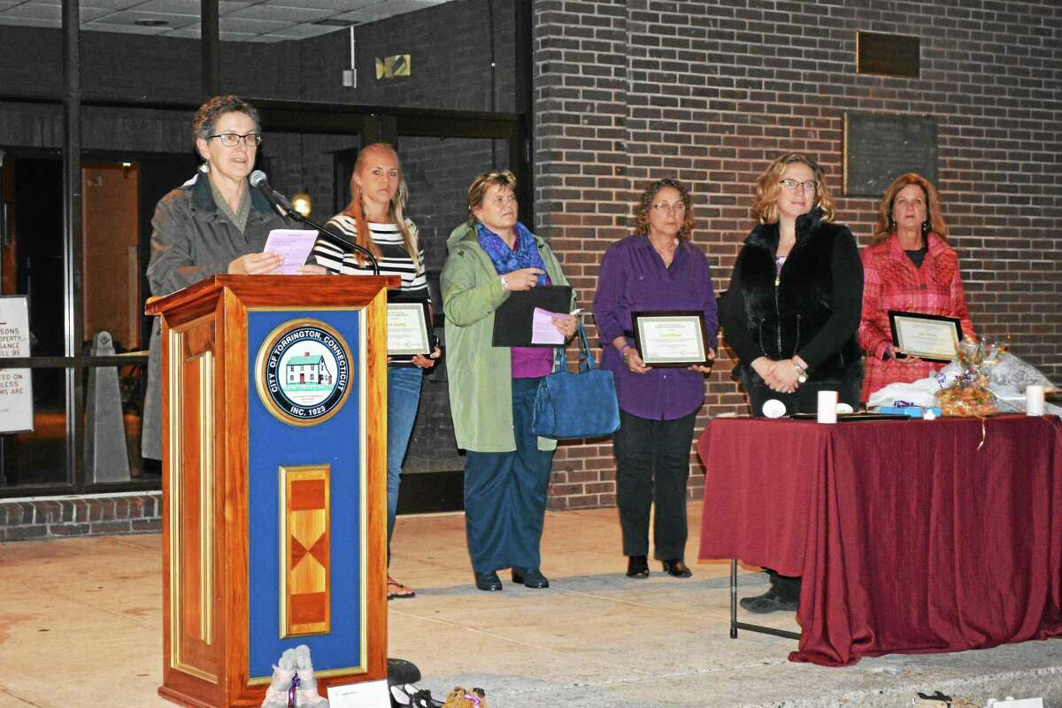 Barbara Spiegel, executive director the Susan B. Anthony Project, handed out plaques to honor several local educators for their work in the community during a vigil at Coe Memorial Park in Torrington.