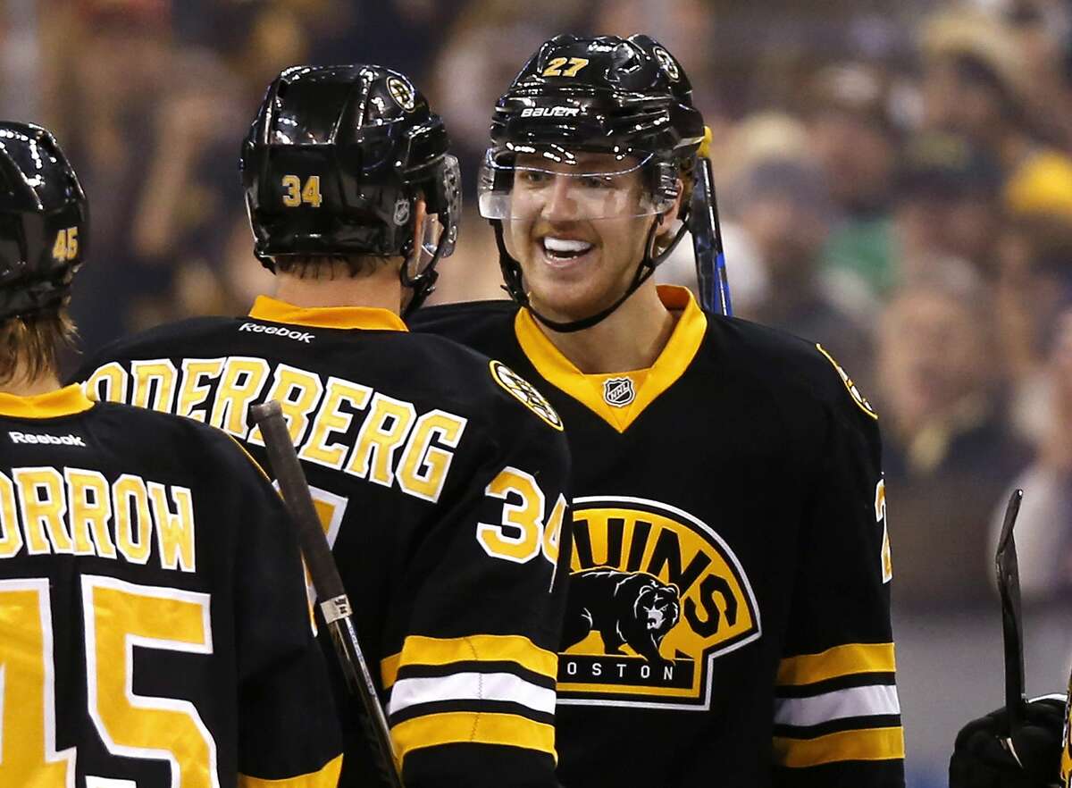 Defenseman Dougie Hamilton, right, is congratulated by Carl Soderberg after Hamilton’s overtime goal gave the Bruins a 2-1 win over the Winnipeg Jets on Friday in Boston.