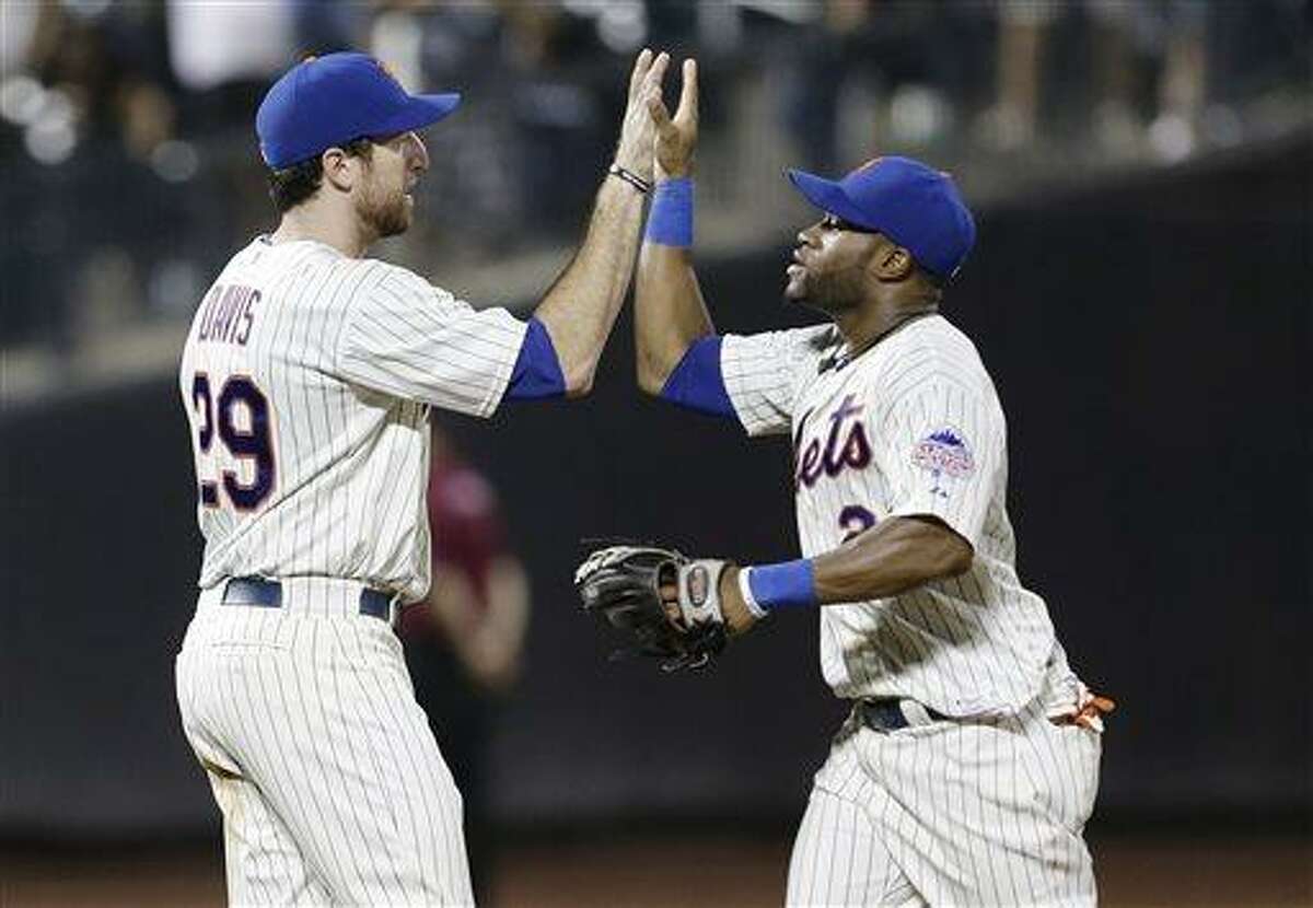 New York Mets' Ike Davis, left, and Eric Young Jr. celebrate after their 4-1 in a baseball game against the Atlanta Braves Tuesday, July 23, 2013, in New York. (AP Photo/Frank Franklin II)