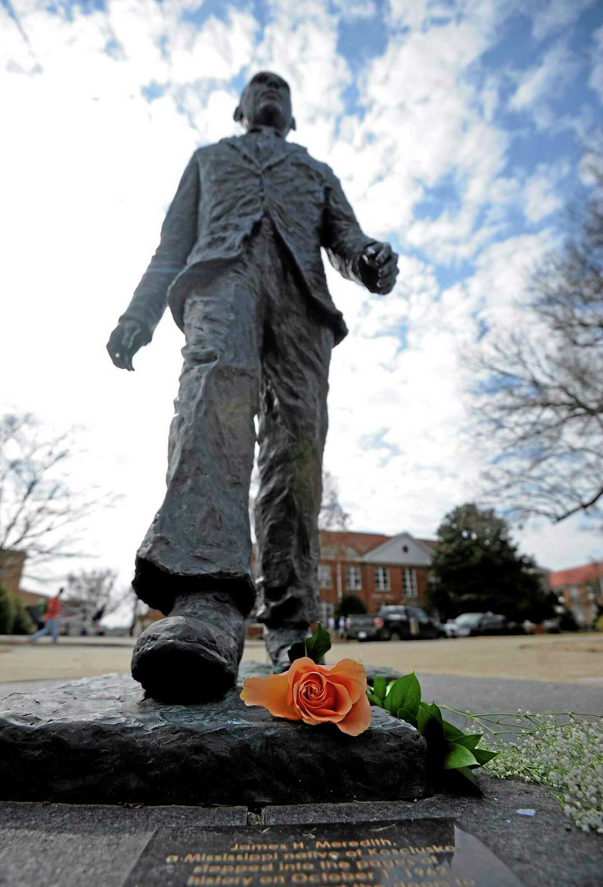 A flower is seen on the James Meredith statue at the University of Mississippi in Oxford, Miss., Tuesday, Feb. 18, 2014. Campus police at the University of Mississippi are checking video surveillance footage in the area around a statue of James Meredith that was found sullied Sunday morning. (AP Photo/The Daily Mississippian, Thomas Graning)
