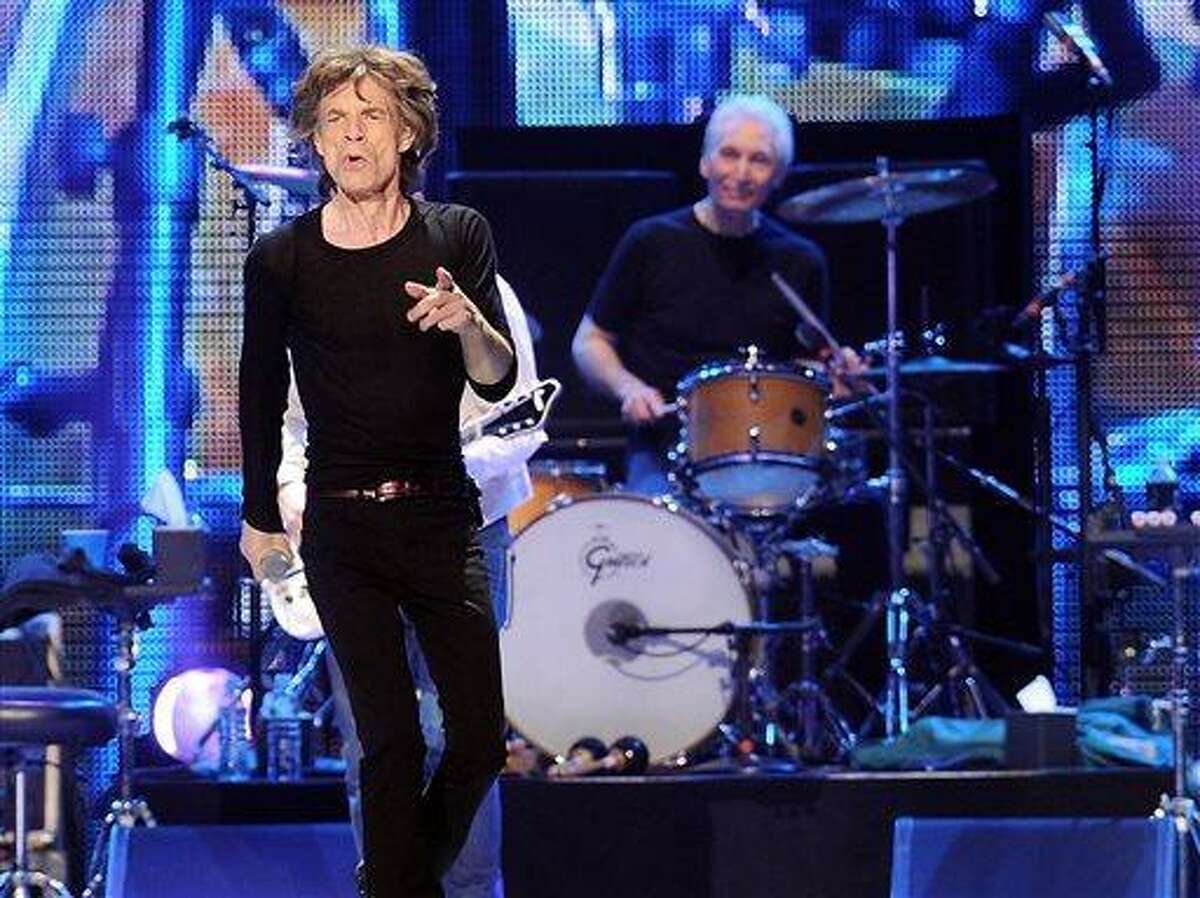 This Dec. 15, 2012 file photo shows lead singer Mick Jagger, left, and Charlie Watts of The Rolling Stones during a performance at the Prudential Center in Newark, N.J. Before they kick off their "50 and Counting" tour, the Rolling Stones are playing a warm-up date in a small club in Los Angeles. The band is due to play the Echoplex on Saturday night before a crowd that will be miniscule compared to the thousands who are set to see them perform May 3 at the Staples Center. (Photo by Evan Agostini/Invision/AP)